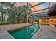 Relaxing screened pool and spa with brick pavers and outdoor bar at 909 Macewen Dr, Osprey, FL 34229