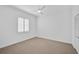 Spacious bedroom with neutral carpet, white walls, and plantation shutters at 909 Macewen Dr, Osprey, FL 34229