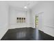 Bright bedroom with dark hardwood floors and access to a private patio at 909 Macewen Dr, Osprey, FL 34229