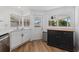 Modern kitchen with white cabinets, wood-look floors, and backyard access at 1160 Morningside Pl, Sarasota, FL 34236
