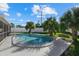 Relaxing kidney-shaped pool with lush landscaping at 1160 Morningside Pl, Sarasota, FL 34236