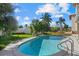 Relaxing kidney-shaped pool with lush landscaping at 1160 Morningside Pl, Sarasota, FL 34236