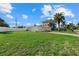 Backyard view showing a large grassy area and a house under construction at 1160 Morningside Pl, Sarasota, FL 34236