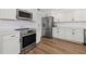 Modern kitchen with stainless steel appliances and white cabinets at 1160 Morningside Pl, Sarasota, FL 34236