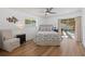 Bedroom with a queen-size bed, wood-look floors, and access to the backyard at 1160 Morningside Pl, Sarasota, FL 34236