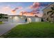 A white house with a garage under a sunset sky at 1160 Morningside Pl, Sarasota, FL 34236