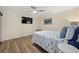 Bedroom with a full-size bed, wood-look floors, and TV at 1160 Morningside Pl, Sarasota, FL 34236