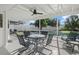 Relaxing screened patio with pool view, table and chairs, and grill at 1160 Morningside Pl, Sarasota, FL 34236