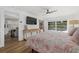 Main bedroom with king bed, hardwood floors, and pool view at 1160 Morningside Pl, Sarasota, FL 34236