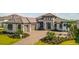 Beautiful single-Gathering home featuring a barrel tile roof, a paved driveway, and a meticulously landscaped front yard at 1107 Blue Shell Loop, Sarasota, FL 34240