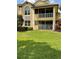 A spacious backyard features lush grass and a screened-in lanai at 6414 Moorings Point Cir # 201, Lakewood Ranch, FL 34202