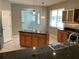 Bright kitchen with an island, stainless steel sink, pendant lighting, and tile flooring at 6414 Moorings Point Cir # 201, Lakewood Ranch, FL 34202