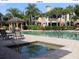 Community pool features a hot tub, seating, and well-maintained landscaping at 6414 Moorings Point Cir # 201, Lakewood Ranch, FL 34202
