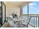 Screened balcony with table and chairs, offering a lake view at 7612 Lake Vista Ct # 405, Lakewood Ranch, FL 34202