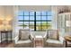 Two chairs and a large window overlooking a lake at 7612 Lake Vista Ct # 405, Lakewood Ranch, FL 34202