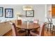 Round dining table with leather chairs and kitchen views at 7612 Lake Vista Ct # 405, Lakewood Ranch, FL 34202