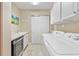 Laundry room with washer, dryer, wine cooler, and ample storage at 7612 Lake Vista Ct # 405, Lakewood Ranch, FL 34202