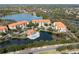 Wide aerial view of community, lake, and road at 7612 Lake Vista Ct # 405, Lakewood Ranch, FL 34202