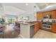 Open concept kitchen boasting granite counters and stainless steel appliances at 7612 Lake Vista Ct # 405, Lakewood Ranch, FL 34202