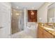 Spa-like bathroom with walk-in shower, soaking tub, and granite vanity at 7612 Lake Vista Ct # 405, Lakewood Ranch, FL 34202