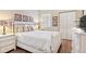 Bright bedroom with white wooden bed frame, nightstands, and hardwood floors at 7612 Lake Vista Ct # 405, Lakewood Ranch, FL 34202