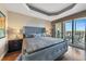 Spacious main bedroom with large bed and access to private balcony at 7612 Lake Vista Ct # 405, Lakewood Ranch, FL 34202