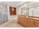 Elegant bathroom with dual vanities, soaking tub, and walk-in shower at 7612 Lake Vista Ct # 405, Lakewood Ranch, FL 34202