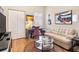 Sitting room with light leather couch, glass coffee table, and wood floors at 7612 Lake Vista Ct # 405, Lakewood Ranch, FL 34202