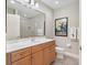 Clean bathroom with light wood vanity, large mirror, and a walk-in shower at 7612 Lake Vista Ct # 405, Lakewood Ranch, FL 34202