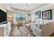 Spacious living room with sectional sofa and hardwood floors at 7612 Lake Vista Ct # 405, Lakewood Ranch, FL 34202