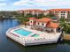 Aerial view of community pool and surrounding buildings at 7612 Lake Vista Ct # 405, Lakewood Ranch, FL 34202