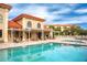 Relaxing resort-style pool with adjacent seating at 7612 Lake Vista Ct # 405, Lakewood Ranch, FL 34202