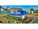 Community entrance sign with landscaping and a paved driveway at 1107 Blue Shell Loop, Sarasota, FL 34240
