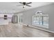 Open living room with kitchen view, pool view, and ceiling fan at 14312 Barbarossa Ln, Port Charlotte, FL 33981
