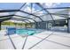 Large screened pool with tiled water feature and adjacent outdoor kitchen at 14312 Barbarossa Ln, Port Charlotte, FL 33981