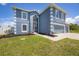 Two-story house with gray siding, white trim, screened porch, and attached two-car garage at 14312 Barbarossa Ln, Port Charlotte, FL 33981