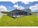 Aerial view of the home showcasing a large backyard with a screened pool at 14312 Barbarossa Ln, Port Charlotte, FL 33981