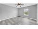 Gray-walled bedroom featuring vinyl flooring and a ceiling fan at 14312 Barbarossa Ln, Port Charlotte, FL 33981