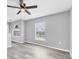 Bedroom with gray walls, vinyl plank flooring, and a ceiling fan at 14312 Barbarossa Ln, Port Charlotte, FL 33981