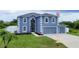 Two-story house with a two-car garage and landscaped lawn at 14312 Barbarossa Ln, Port Charlotte, FL 33981