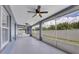 Spacious screened porch with ceiling fans, offering a shaded outdoor space at 14312 Barbarossa Ln, Port Charlotte, FL 33981