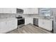 Modern kitchen with white shaker cabinets, stainless steel appliances, and quartz countertops at 14312 Barbarossa Ln, Port Charlotte, FL 33981