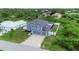 Aerial view of a two-story house with a two-car garage and fenced backyard at 14312 Barbarossa Ln, Port Charlotte, FL 33981