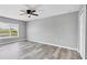 Bedroom with gray walls, vinyl plank flooring, and a window at 14312 Barbarossa Ln, Port Charlotte, FL 33981