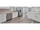 Modern kitchen with white cabinets, stainless steel appliances, and quartz countertops at 14312 Barbarossa Ln, Port Charlotte, FL 33981
