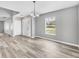 Dining area features neutral gray walls, wood-look flooring, and a large window at 14312 Barbarossa Ln, Port Charlotte, FL 33981