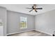 Bright bedroom with gray walls, vinyl plank flooring, and a ceiling fan at 14312 Barbarossa Ln, Port Charlotte, FL 33981