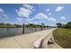 Peaceful waterfront walkway with bench overlooking canal at 14312 Barbarossa Ln, Port Charlotte, FL 33981