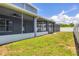 Landscaped backyard with screened patio and pool visible in the background at 14312 Barbarossa Ln, Port Charlotte, FL 33981