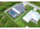 Aerial view showing two houses, one with a pool and screened enclosure at 14312 Barbarossa Ln, Port Charlotte, FL 33981